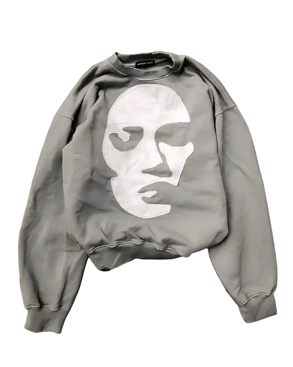 Gray oversized sweatshirt flat lay showing white stick-appliquéd face with eye openings