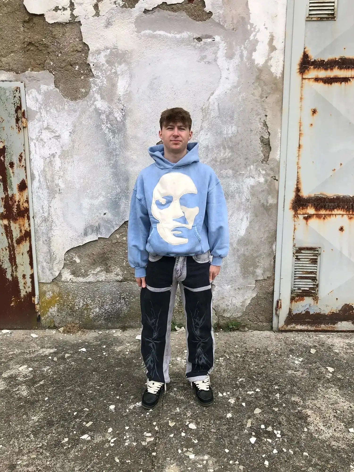 Frontal shot of model wearing loose-fit Faceless hoodie with abstract chest graphic