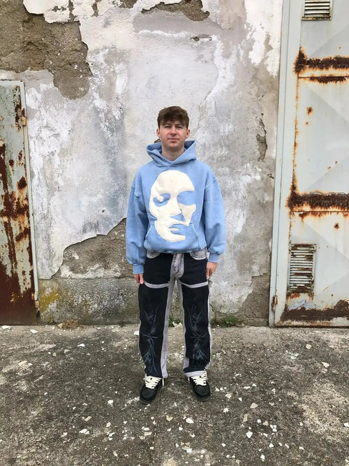 Frontal shot of model wearing loose-fit Faceless hoodie with abstract chest graphic