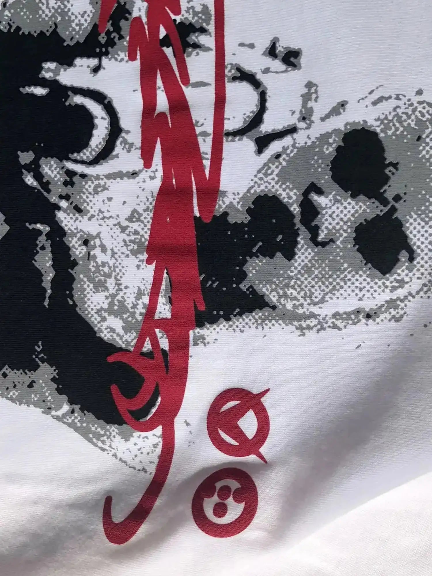 White cotton t-shirt fabric detail with halftone portrait and red abstract graphic print